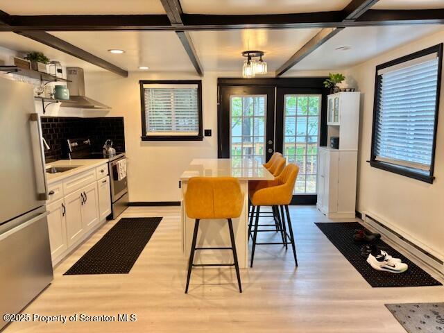 1717 Rolling Hills Dr, Tobyhanna, PA 18466 - dining space featuring light wood finished floors, a baseboard heating unit, beam ceiling, coffered ceiling, and recessed lighting