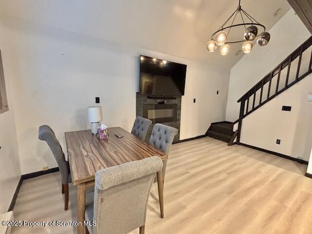 1717 Rolling Hills Dr, Tobyhanna, PA 18466 - dining area featuring a chandelier, light wood-type flooring, and stairway