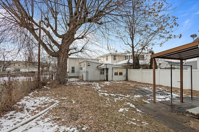yard covered in snow featuring a fenced backyard
