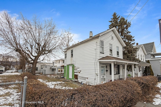 view of snow covered exterior featuring covered porch