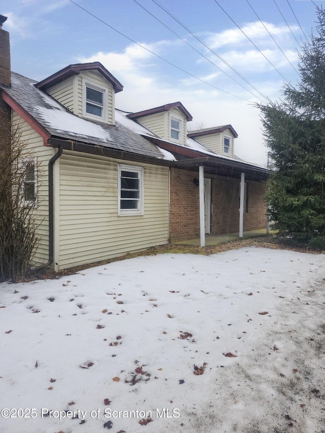 exterior space featuring brick siding