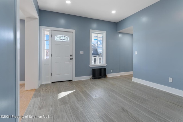 entrance foyer featuring light hardwood / wood-style floors and radiator