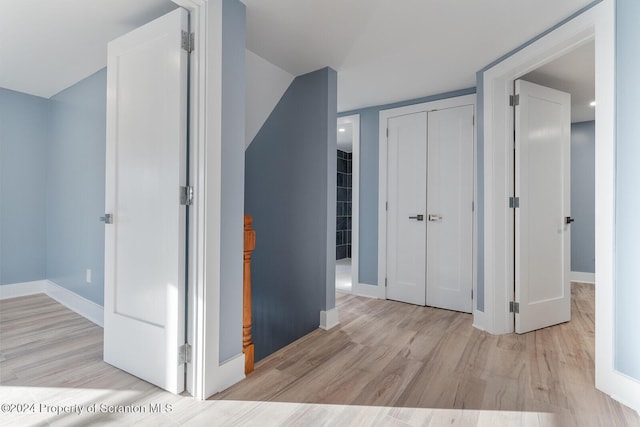 corridor with light wood-type flooring