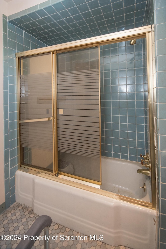 bathroom featuring tile patterned floors and enclosed tub / shower combo