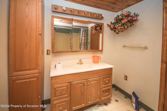 bathroom with tile patterned flooring, vanity, and wood ceiling