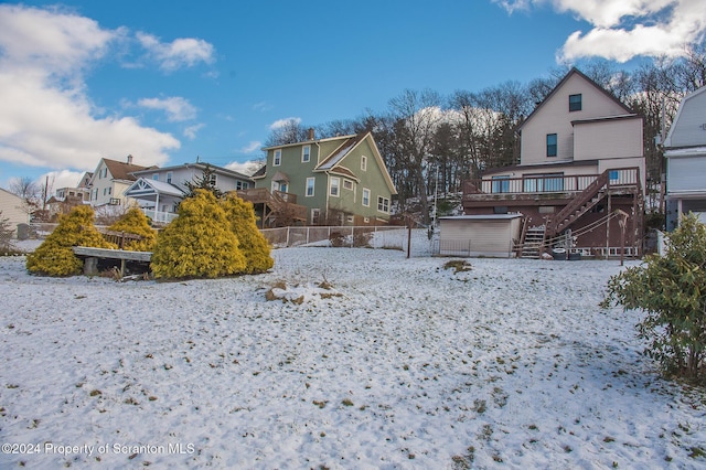 snowy yard featuring a deck