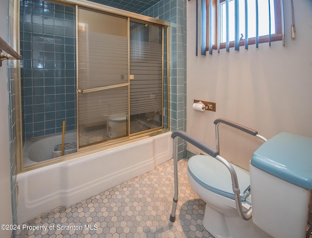 bathroom with shower / bath combination with glass door, tile patterned floors, and toilet