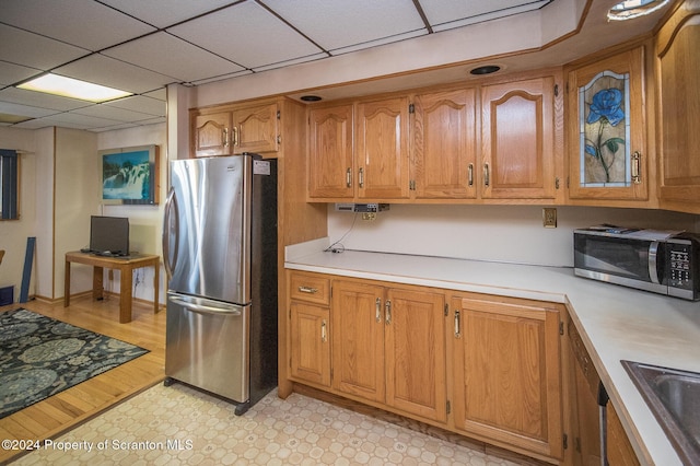 kitchen featuring a paneled ceiling, sink, and appliances with stainless steel finishes