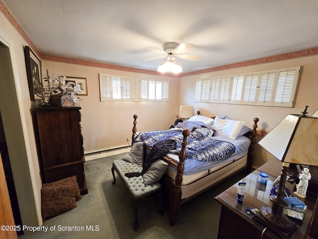 bedroom featuring ceiling fan, dark carpet, and a baseboard heating unit