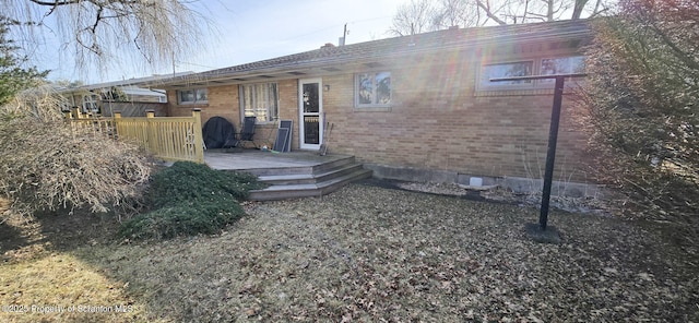 rear view of property featuring a deck