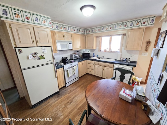 kitchen featuring wood-type flooring, sink, light brown cabinetry, and white appliances