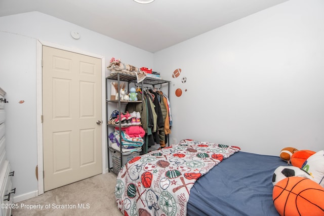 bedroom featuring light carpet and a closet