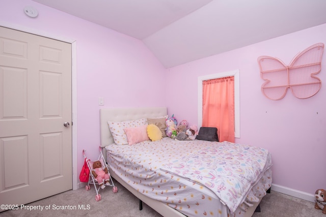 carpeted bedroom featuring vaulted ceiling