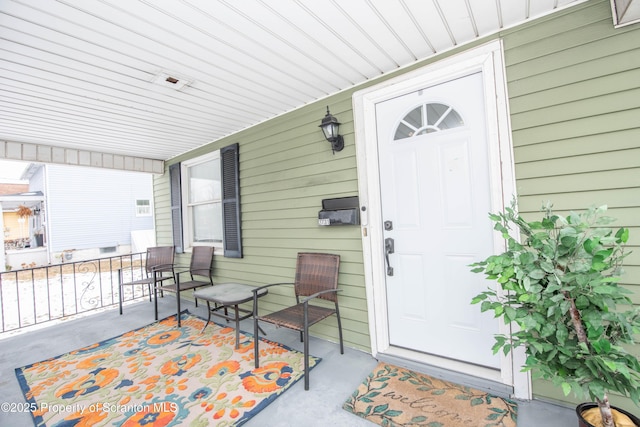 view of exterior entry with a porch