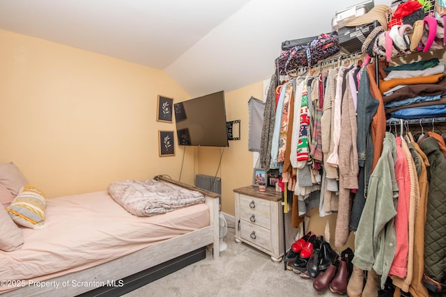 carpeted bedroom featuring lofted ceiling