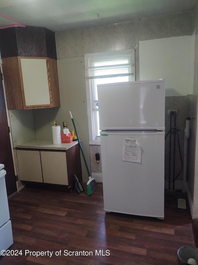 kitchen featuring dark wood-type flooring and white refrigerator