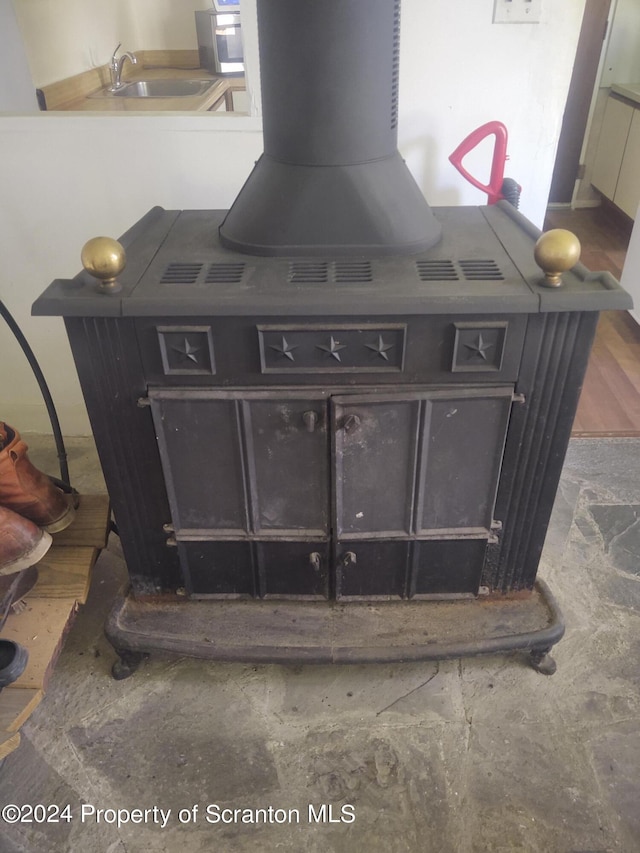 interior details with a wood stove and sink