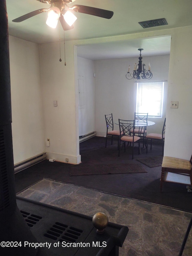 dining room featuring a baseboard radiator and ceiling fan with notable chandelier