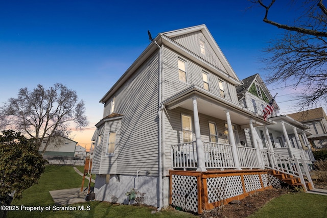 view of front of home with a porch and a front yard