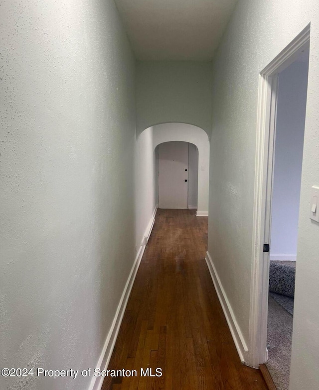 corridor featuring dark hardwood / wood-style floors