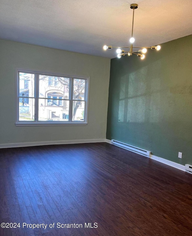 empty room featuring dark hardwood / wood-style floors, a textured ceiling, a chandelier, and a baseboard radiator