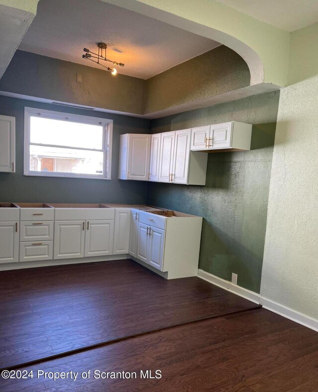 kitchen featuring white cabinets and dark hardwood / wood-style floors