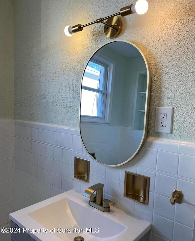 bathroom with decorative backsplash, tile walls, and vanity