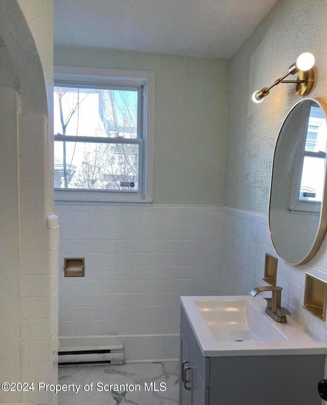 bathroom with vanity and tile walls