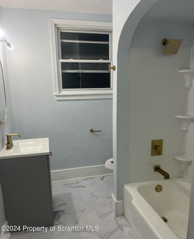 full bathroom featuring washtub / shower combination, vanity, and toilet