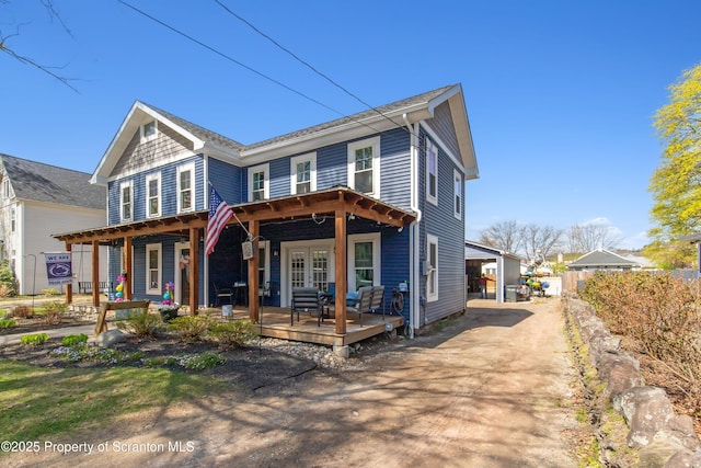view of front of home with fence, french doors, and a deck