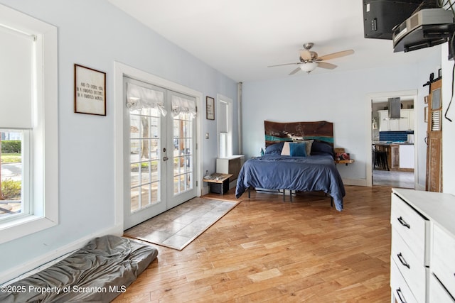 bedroom with light wood finished floors, french doors, a ceiling fan, and access to exterior