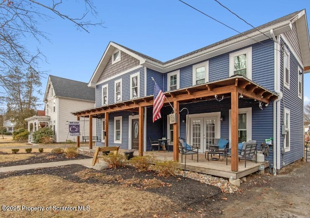 view of front of house featuring a porch and french doors