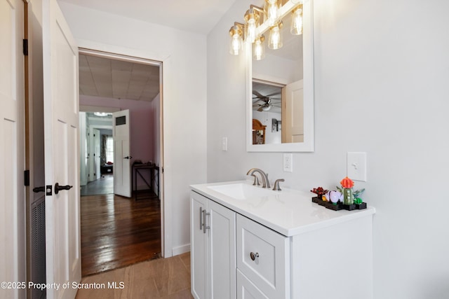 bathroom featuring wood finished floors, a ceiling fan, and vanity