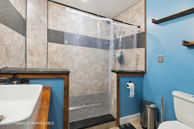 bathroom with toilet, vanity, and a shower with curtain