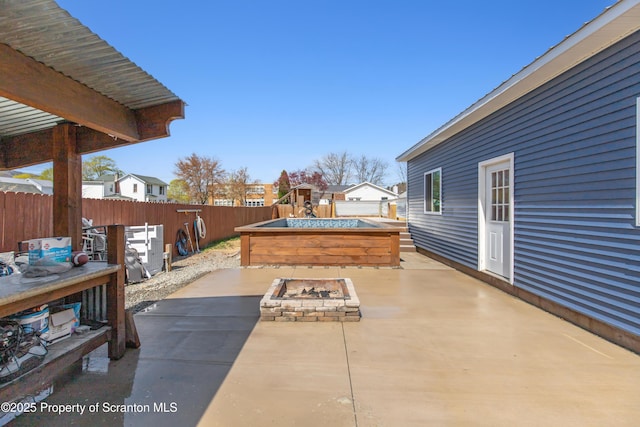 view of patio / terrace with a fire pit and a fenced backyard