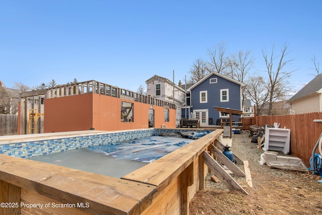 view of swimming pool featuring fence and a fenced in pool