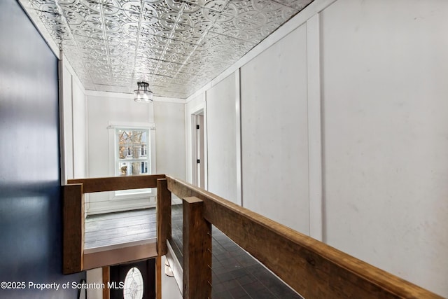 hall featuring an ornate ceiling and an upstairs landing
