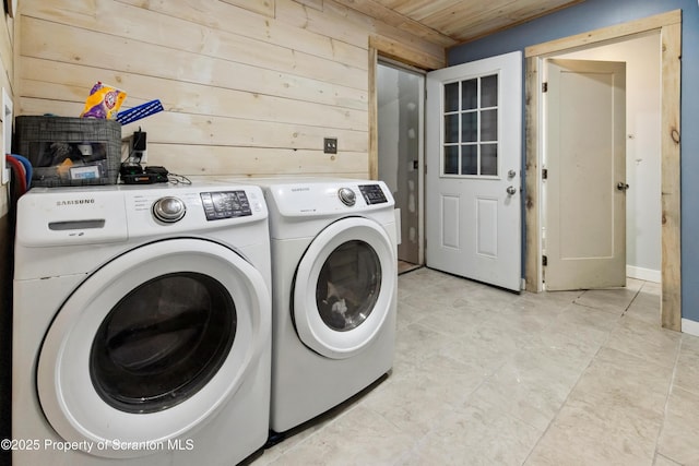 laundry room with independent washer and dryer, wood walls, wood ceiling, and laundry area