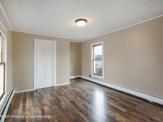 unfurnished bedroom with crown molding, a baseboard radiator, dark hardwood / wood-style floors, and a closet