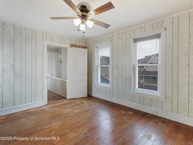 unfurnished room with hardwood / wood-style flooring, ornamental molding, and ceiling fan