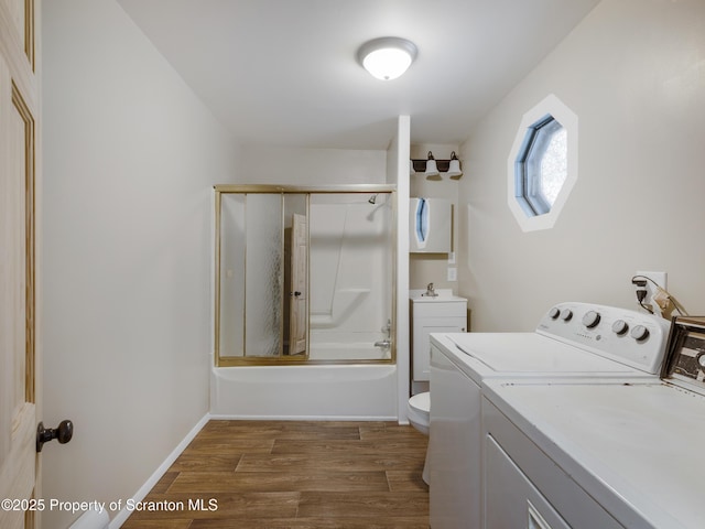 laundry room with dark hardwood / wood-style floors and washing machine and dryer