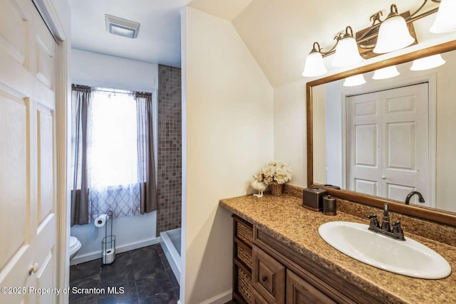 bathroom with walk in shower, tile patterned floors, vanity, and toilet