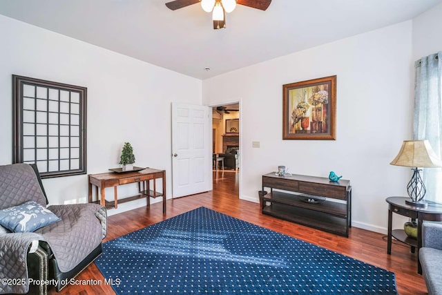 sitting room with hardwood / wood-style flooring and ceiling fan