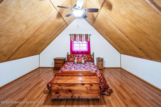 bedroom featuring wood-type flooring, ceiling fan, and vaulted ceiling