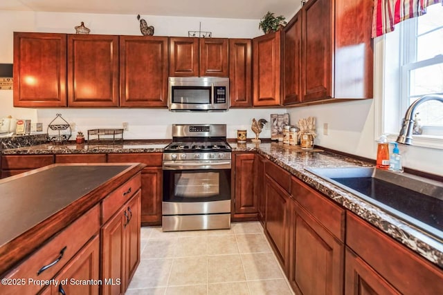 kitchen featuring light tile patterned floors, sink, and appliances with stainless steel finishes