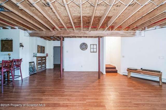 basement with baseboard heating and wood-type flooring