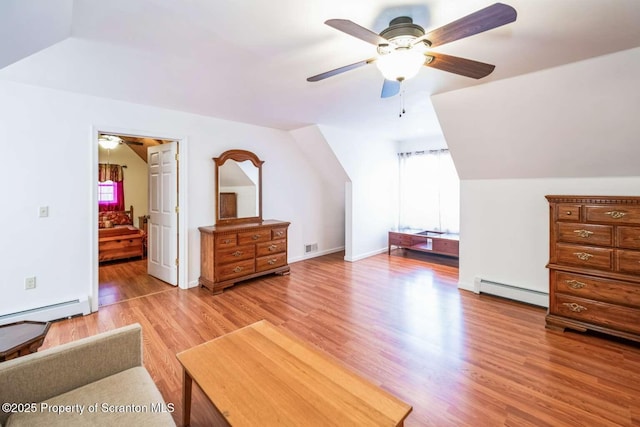 bonus room featuring vaulted ceiling, a baseboard radiator, ceiling fan, and light hardwood / wood-style floors