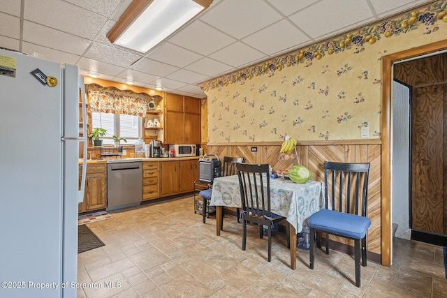 934 W Market St, Scranton, PA 18508 - kitchen featuring appliances with stainless steel finishes, a drop ceiling, wallpapered walls, wainscoting, and open shelves