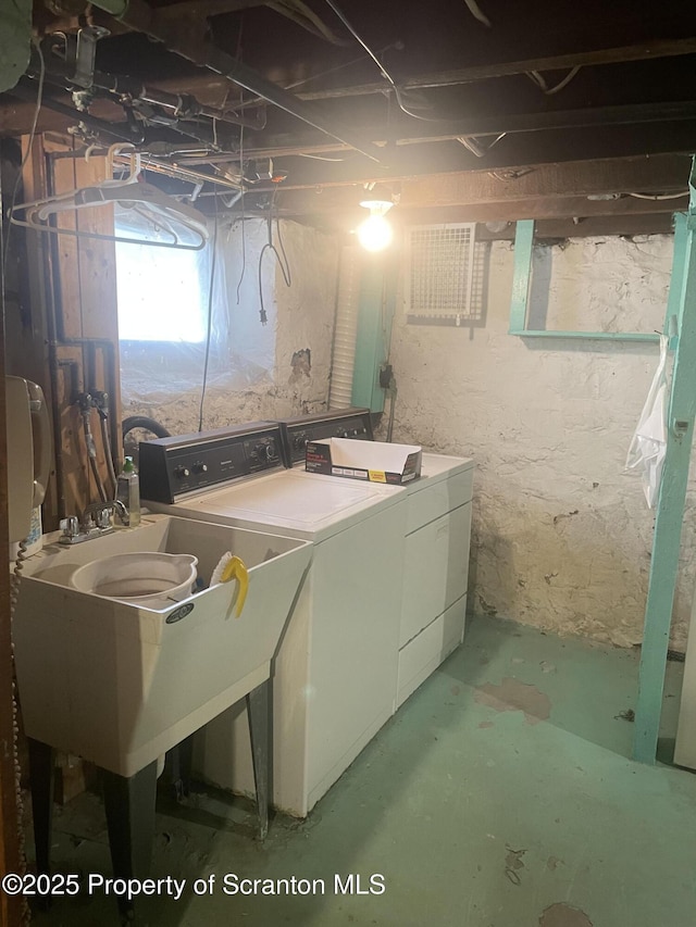 laundry room with laundry area, a sink, and washer and clothes dryer