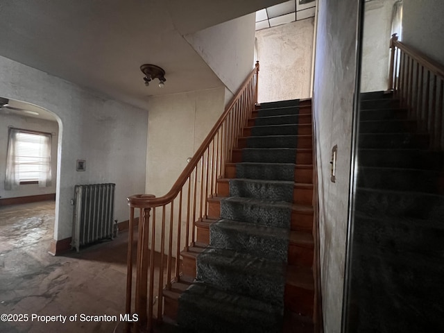 826 N Main St, Forest City, PA 18421 - staircase featuring radiator heating unit and arched walkways